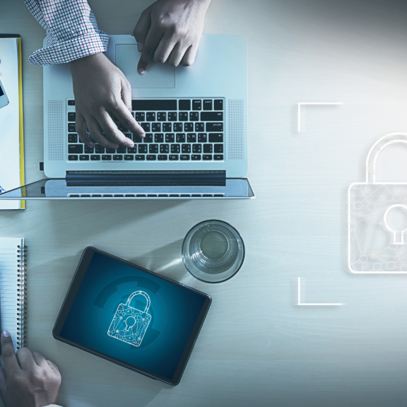 Overhead image of someone working on a laptop and collaborating with others