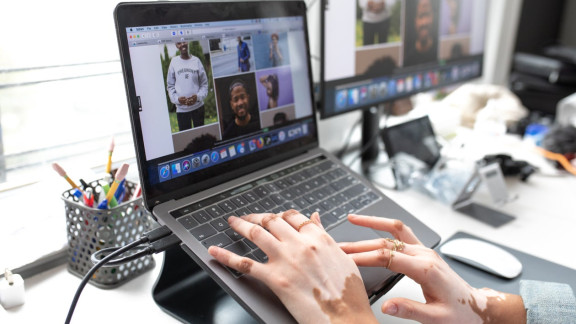 Hands on a laptop working to select images