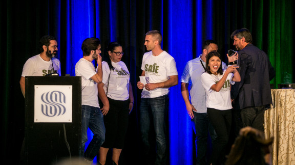 Group of People On a Stage Receiving An Award