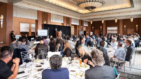 People in a luncheon room at tables