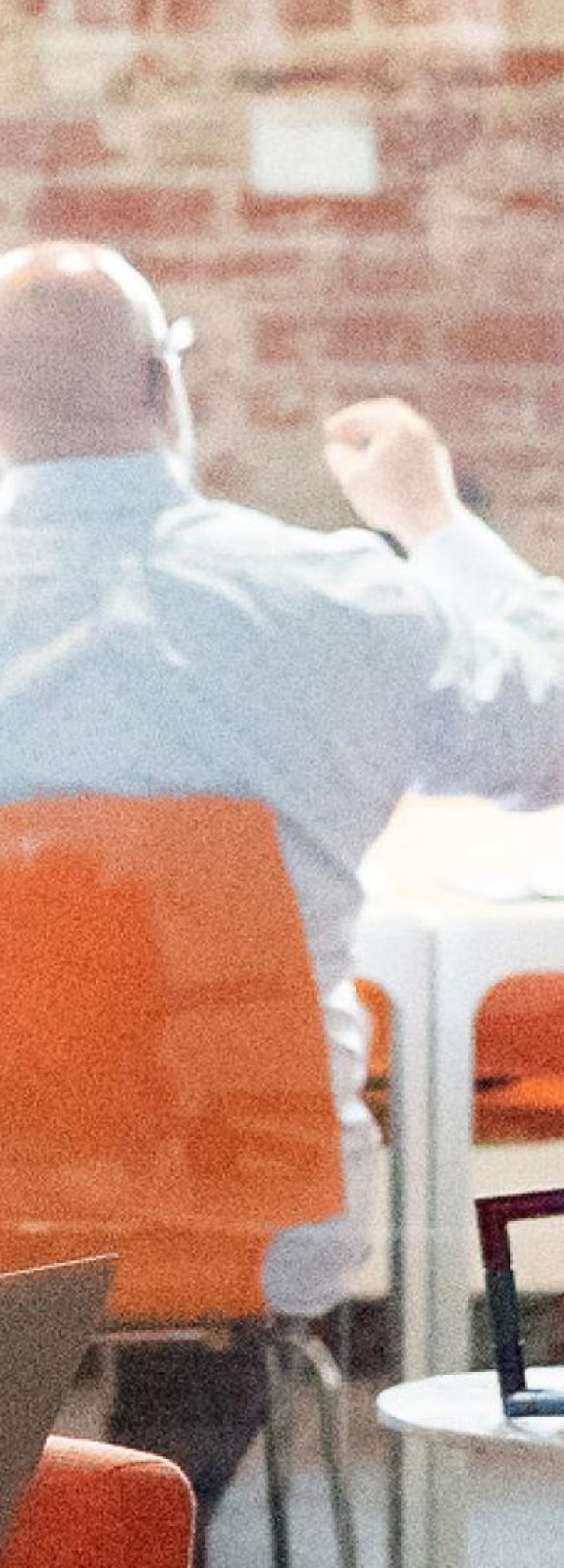 Image of conference room and Message Agency staff in a meeting