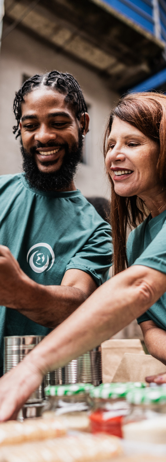 Two volunteers at a food bank looking at an iPad