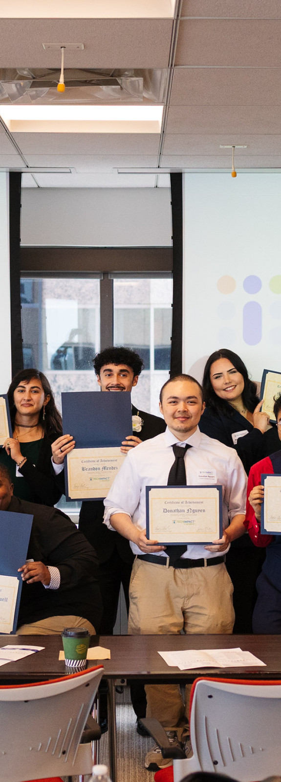 Group of students holding up certificates