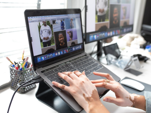 Hands on a laptop working to select images