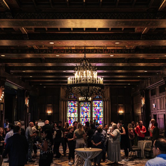 Crowd of Attendees Networking in a Historical Ballroom