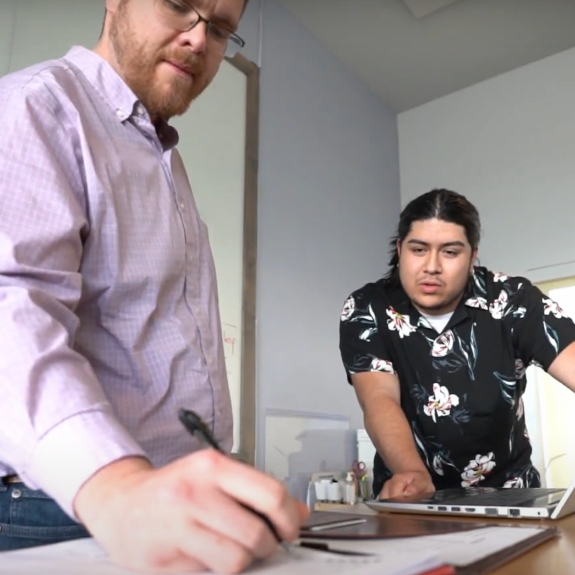 Two men looking at a computer