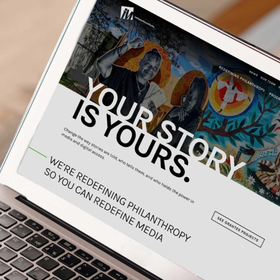 Laptop showing the Independence Public Media Foundatiom homepage which reads "Your Story Is Yours"