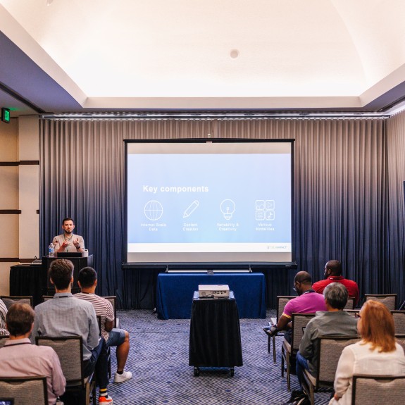 Conference breakout room with a speaker and slides