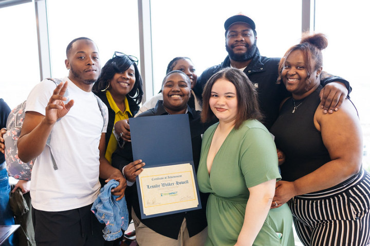 A family posing for a picture around a graduate