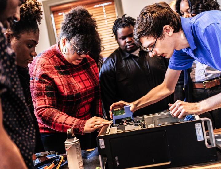 Students working on the motherboard of a computer