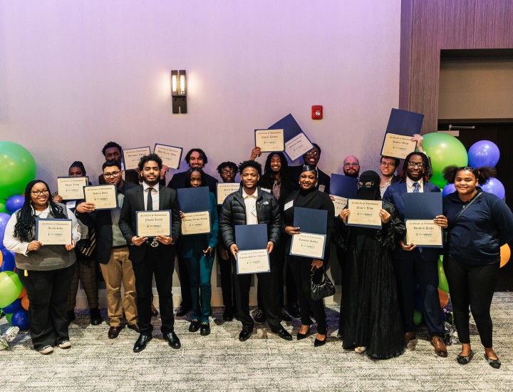 Group of graduates holding certificates