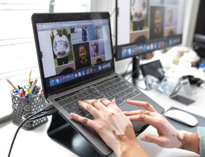 Hands on a laptop working to select images